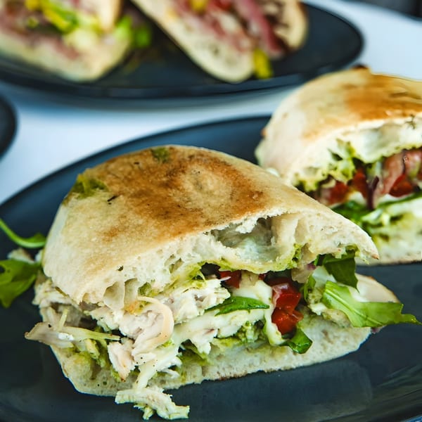 Close-up of a Boa's CVC pita sandwich filled with chicken, lettuce, and sun-dried tomatoes.